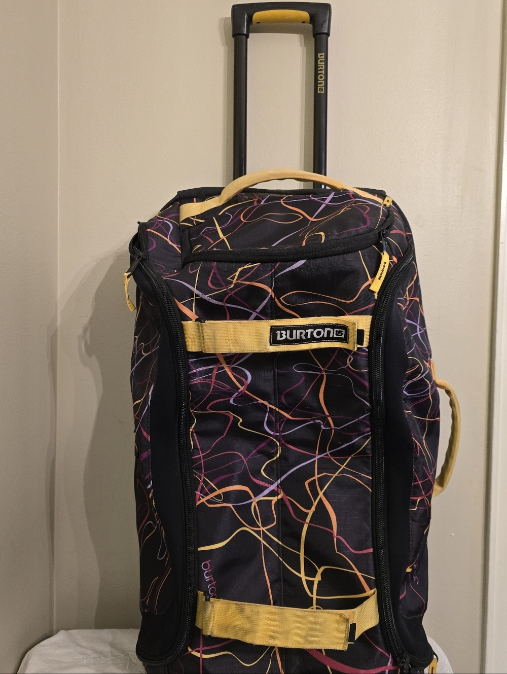 Burton Black Rolling Duffel with Yellow and Multicolor Line Pattern